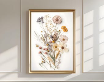 Op de afbeelding: Een ingelijste print van een gedroogde bloemenarrangement met een witte achtergrond. De bloemen zijn in tinten roze, geel en wit, en de stelen zijn bruin en groen.