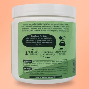 May include: White plastic bottle with a green label. The label has text that reads "Support your pet's bladder function and overall urinary health with a blend of D-mannose and cranberry, known for their natural properties. Combined with prebiotics to help maintain a balanced microbiome, this formula is best used regularly for ongoing care." The label also includes directions for use, a warning, and a caution.