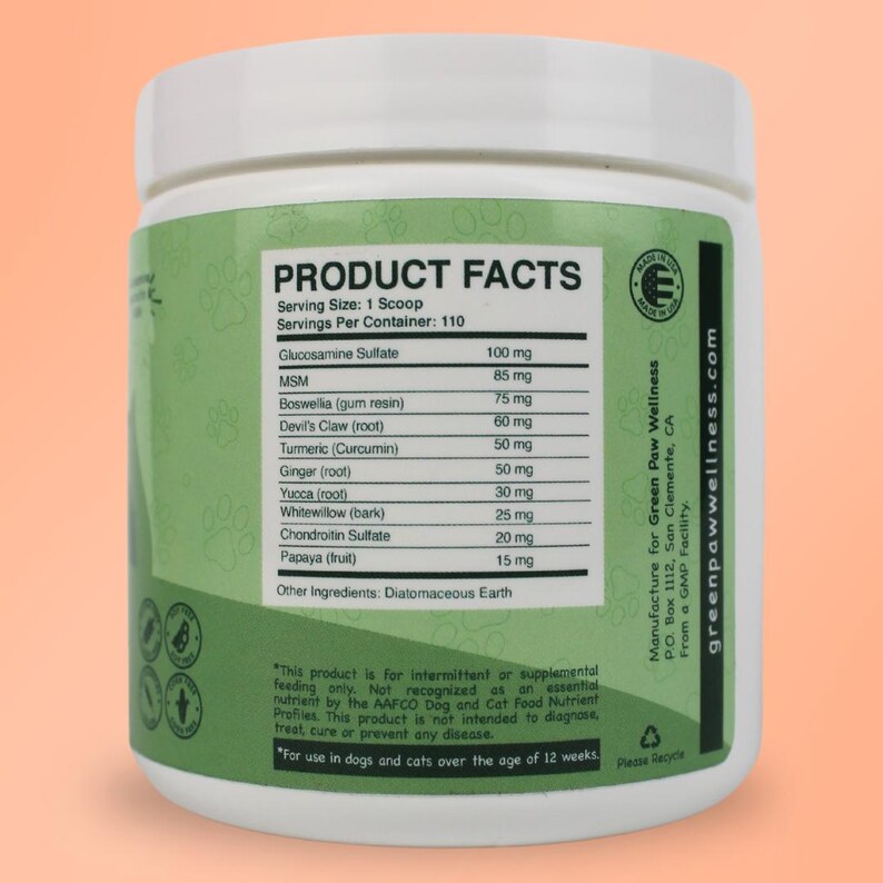 May include: A white plastic jar with a green label that says "Product Facts" and lists the ingredients and dosage of a supplement for dogs and cats. The label also includes the company name "Green Paw Wellness" and their website address.