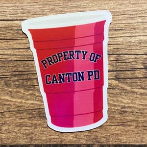 May include: Red plastic cup with the text "PROPERTY OF CANTON PD" in blue lettering.