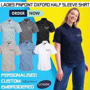 May include: An advertisement for women's pinpoint Oxford half-sleeve shirts in a range of colours, such as light blue, grey, black, and white. Each shirt features the text "Your Text Here" embroidered on the chest. The image also includes the text "ORDER NOW" and "PERSONALISED CUSTOM EMBROIDERED".