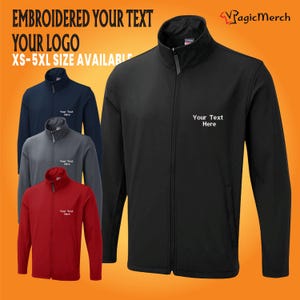 May include: Black, red, navy blue, and grey softshell jackets with a zip closure. The jackets have a stand-up collar and are embroidered with the text "Your Text Here".