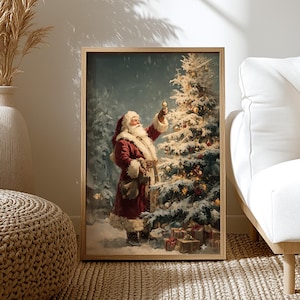 May include: A framed print depicts Santa Claus decorating a Christmas tree in a snowy forest. Santa, in a red suit with white trim, holds a golden ornament. The tree is adorned with lights and ornaments, with wrapped gifts at its base. The artwork is set in a wooden frame.