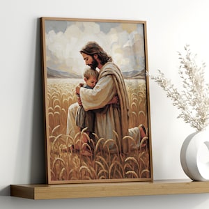 May include: A framed print depicts a tender scene of a figure in flowing robes embracing a child. The artwork is set in a wheat field, with a soft, warm color palette. The frame is a light brown color.