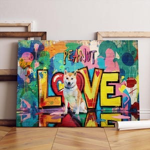 May include: A canvas print featuring a Shiba Inu dog sitting in front of graffiti art. The artwork spells out "LOVE" in large, colorful letters, with "PEANUT" above. The background is a vibrant mix of colors.