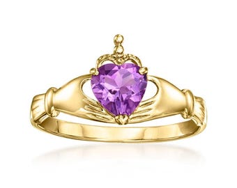 May include: A gold-toned Claddagh ring featuring a heart-shaped purple gemstone. The heart is crowned and held by two hands. The ring is a symbol of love, loyalty, and friendship.