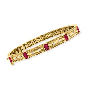 May include: A gold bangle bracelet with rectangular red gemstones and small white gemstones. The bracelet has a textured design and a clasp closure. The jewelry is displayed on a white background.