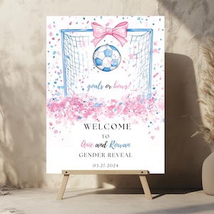 May include: A gender reveal party sign with a blue and pink soccer ball in a goal. The sign says "Welcome to [Name] and [Name] Gender Reveal 01.27.2024" and "Goals or Bows?"