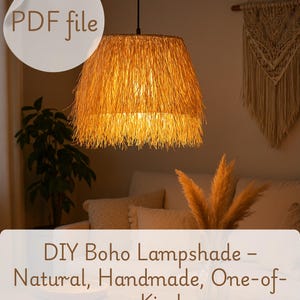 May include: A DIY boho lampshade made from natural materials. The lampshade is a light brown color and has a fringed edge. The lampshade is hanging from a black cord and is lit, casting a warm glow.