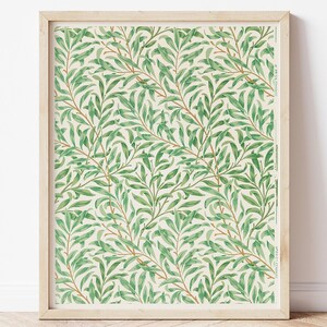 May include: A framed print of a vintage botanical illustration featuring a repeating pattern of green leaves and branches on a cream background.