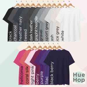 May include: A variety of t-shirts in different colors, including black, charcoal, heather navy, tweed, dark heather, graphite heather, gravel, sport grey, ash, ice grey, white, heliconia, coral silk, light pink, berry, purple, lilac, and black berry.