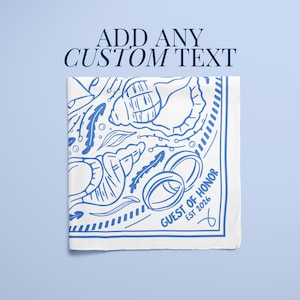 A bright blue and white beach-themed bridesmaid scarf customized with monogram details and seashell artwork, designed as a wedding bandana or bridal accessory, suitable for group orders, wholesale gifts, or coordinated bride tribe outfits for a seaside wedding event.
