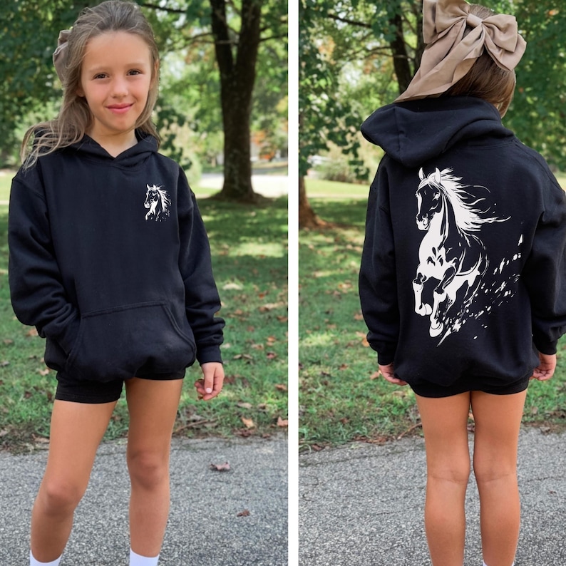 Teen girl in a cozy horse lover sweatshirt, showing the back graphic of a galloping horse.