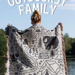 Keepsake Gift For the outdoorsy family and women wearing custom family name blanket with an outdoor design, ideal camping throw for couples, van life gift or camping trip family gift. This premium woven blanket is the perfect family blanket for outdoor lovers, ideal as a garden blanket, cozy cabin blanket, a travel blanket or forest themed home decor blanket