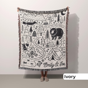 Man holding custom camping throw with unique outdoor design in ivory, a great camping gift for couples or an outdoorsy couple wedding gift idea.