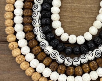 May include: A set of six strands of wooden beads, each strand featuring a different pattern. The beads are round and have a smooth, polished finish. The patterns include a simple floral design, a concentric circle design, and a solid color. The beads are strung on a clear cord.