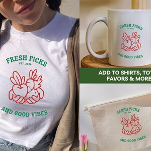 May include: White t-shirt, mug, and canvas bag featuring a red and green graphic with the text "FRESH PICKS EST. 2026 AND GOOD VIBES." The design includes a heart and vegetable illustration. The image also includes the text "ADD TO SHIRTS, TOTES, FAVORS & MORE!"
