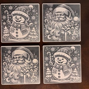 May include: Four square coasters with festive Christmas designs. Two coasters feature Santa Claus with gifts and candy canes, and two feature a smiling snowman with a candy cane. The coasters are black and white.