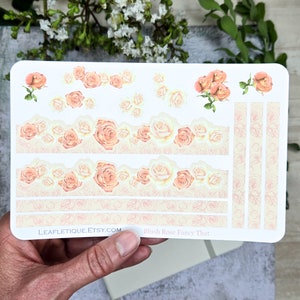 May include: A sheet of planner stickers featuring blush pink roses in various arrangements. The stickers include a border of roses, individual roses, and a set of vertical rose-patterned dividers. The text "Blush Rose Fancy That" and "LEAFLETIQUE.ETSY.COM" are printed at the bottom of the sheet.