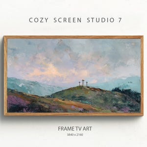 May include: A framed landscape painting with a wooden frame. The artwork depicts a mountain scene with three crosses atop a hill, under a cloudy sky. The text "COZY SCREEN STUDIO 7" and "FRAME TV ART" are visible.