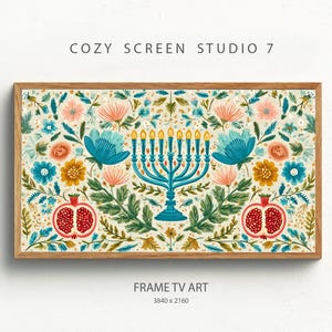 May include: A framed print featuring a teal menorah, pomegranates, and a floral pattern in pink, blue, and yellow. The text "COZY SCREEN STUDIO 7" and "FRAME TV ART" are visible. The frame is made of wood.