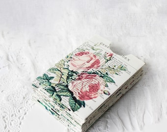 May include: A stack of small, rectangular cards featuring a vintage floral design with pink roses and green leaves. The cards have a distressed, aged appearance, with text visible in the background. The top card has the word "INDEX" printed on it.