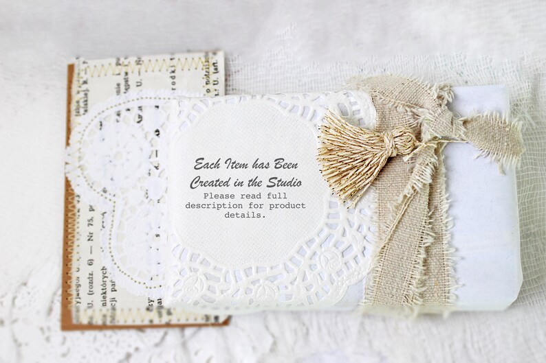 May include: A white gift box wrapped in burlap and lace with a small, beige tassel. The box has a white label with the text "Each Item has Been Created in the Studio. Please read full description for product details."