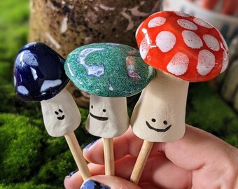 Magical Mushroom garden planter stakes handmade ceramic with blue, red, and jade green tops