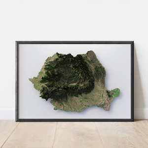 May include: A framed 3D map of Romania, showcasing the country's topography with detailed relief. The map features shades of green and brown, representing forests and mountains, set against a white background. The frame is black.