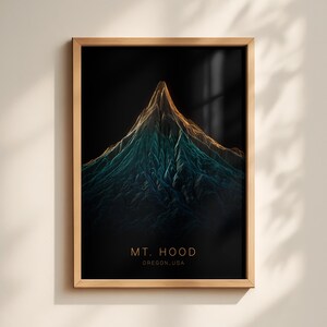 May include: A framed art print displaying a 3D topographic rendering of Mt. Hood in Oregon, USA. The artwork depicts the mountain in teal, orange, and gold hues against a black backdrop. The text "MT. HOOD OREGON, USA" is printed at the bottom.