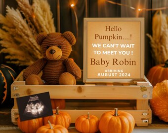 May include: A wooden crate with a sign that reads "Hello Pumpkin....! We can't wait to meet you! Baby Robin Arriving August 2024". There is a teddy bear, a sonogram, and several pumpkins in the crate.