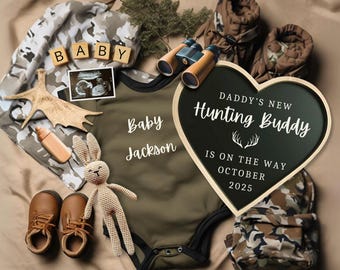 May include: A green and brown camouflage baby onesie with the text "Baby Jackson" on it. A heart-shaped chalkboard sign with the text "Daddy's New Hunting Buddy is on the way October 2025". A pair of brown baby booties, a small stuffed bunny, a pair of binoculars, and a baby ultrasound image.