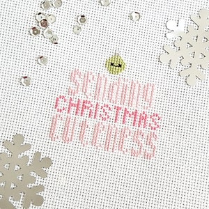 May include: White fabric with pink cross-stitch embroidery that reads "Sewing Christmas Cookies". The fabric is decorated with silver glitter snowflakes and a green and yellow ornament.