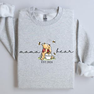 a gray shirt with a picture of a teddy bear on it