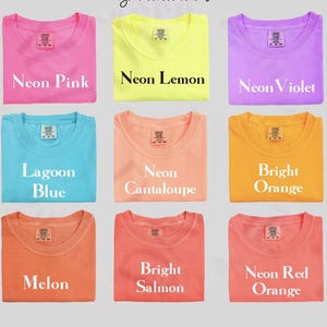 a collection of nine colorful t-shirts, each with a different color and design, arranged in a 3x3 grid.