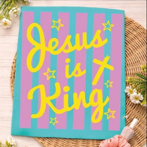 A colorful poster with the text "Jesus is King" in yellow and pink letters, surrounded by pink and purple stripes and stars.