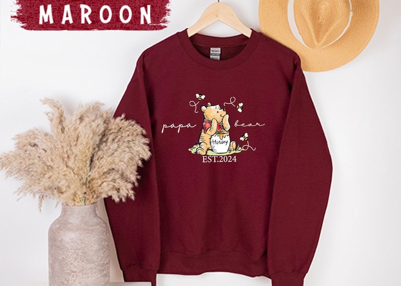 a red sweatshirt with a picture of a bear on it