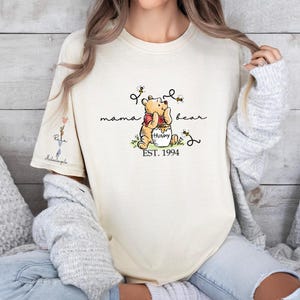 a woman wearing a winnie the pooh t - shirt