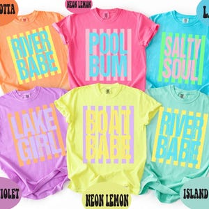 a collection of six colorful t-shirts, each with a different design and color, arranged in a grid-like pattern.