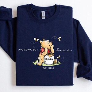 a blue shirt with a winnie the pooh on it