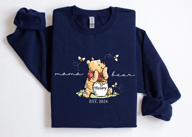 a blue shirt with a winnie the pooh on it