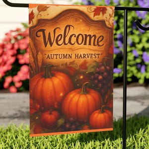 May include: A garden flag with an autumnal design. The flag reads "Welcome" above "Autumn Harvest", with illustrations of pumpkins, grapes, and leaves. The flag is predominantly orange, brown, and red.