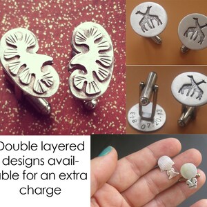May include: A pair of silver cufflinks with a kidney design. The cufflinks are double layered and available for an extra charge. "Double layered designs available for an extra charge" is written below the cufflinks.