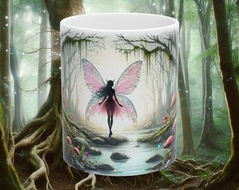 May include: White ceramic mug featuring a fantasy illustration of a fairy with pink and blue wings standing in a forest scene. The fairy is silhouetted against a backdrop of trees, water, and flowers. The mug has a glossy finish and is suitable for hot or cold beverages.