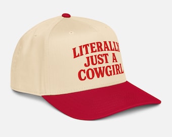 May include: A baseball cap with a cream-colored crown and a red brim. The cap features the text "LITERALLY JUST A COWGIRL" in red block letters. The cap has a red button on top.