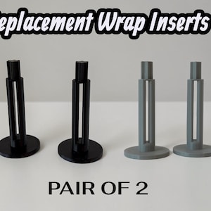 May include: Four replacement wrap inserts, two black and two gray, each featuring a circular base, a vertical cylindrical body with a central cutout, and a smaller top post. The text Replacement Wrap Inserts and PAIR OF 2 is visible.