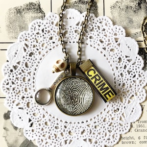 True Crime Necklace with Vintage Fingerprint Pendant and Magnifying Glass, Skull, & Crime Scene Ribbon Tape Charms, True Crime Junkie Gift