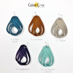 May include: Five pairs of leather earrings in different colors: dark teal, caramel, taupe, eggplant, and seafoam green. Each earring is a twisted, teardrop shape with a silver hook.