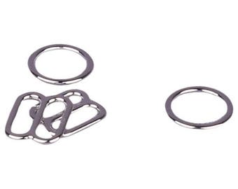 May include: A set of silver metal rings, including three oval-shaped rings and two round rings.