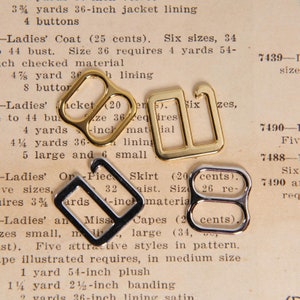 May include: Three metal bra strap sliders. One is gold, one is silver, and one is a combination of gold and silver. The sliders are on a piece of paper with text that reads "Ladies' Coat (25 cents). Six sizes, 34 to 44 bust. Size 36 requires 4 yards 54-inch checked material 4 7/8 yard 36-inch lining 8 buttons".